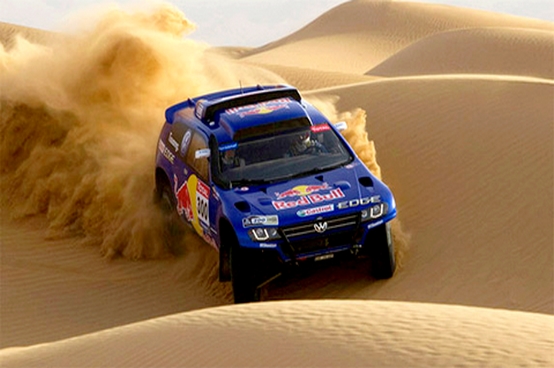 Rally racing car in dunes